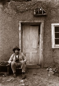 Alan siting infront of abode, El Rito. In Shelter Book.